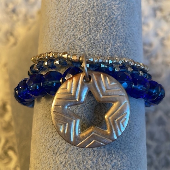 Set of 3 connected blue and silver jewel like bracelets with a star charm. - Picture 2 of 5